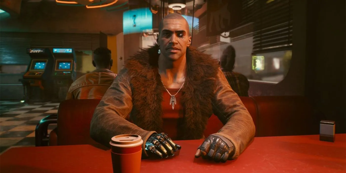 River Ward, một thám tử NCPD và tùy chọn lãng mạn tiềm năng trong Cyberpunk 2077, ngồi tại một quán ăn.